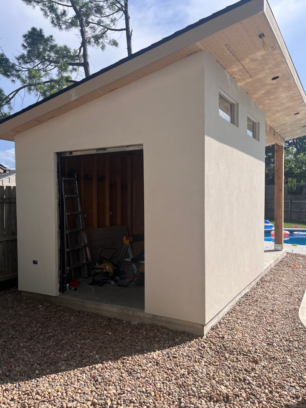 After: the same backyard studio finished in smooth white stucco